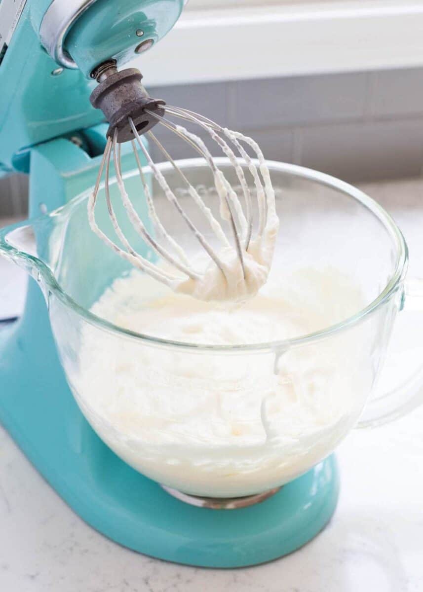 homemade whipped cream in a blue kitchen aid mixer