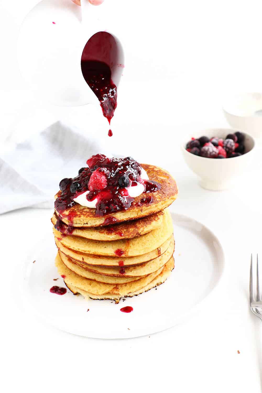 gluten free pancakes with berry coulis on plate