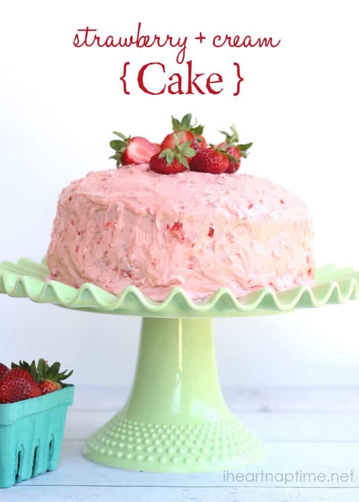 frosted strawberry cream cake on a green cake stand 