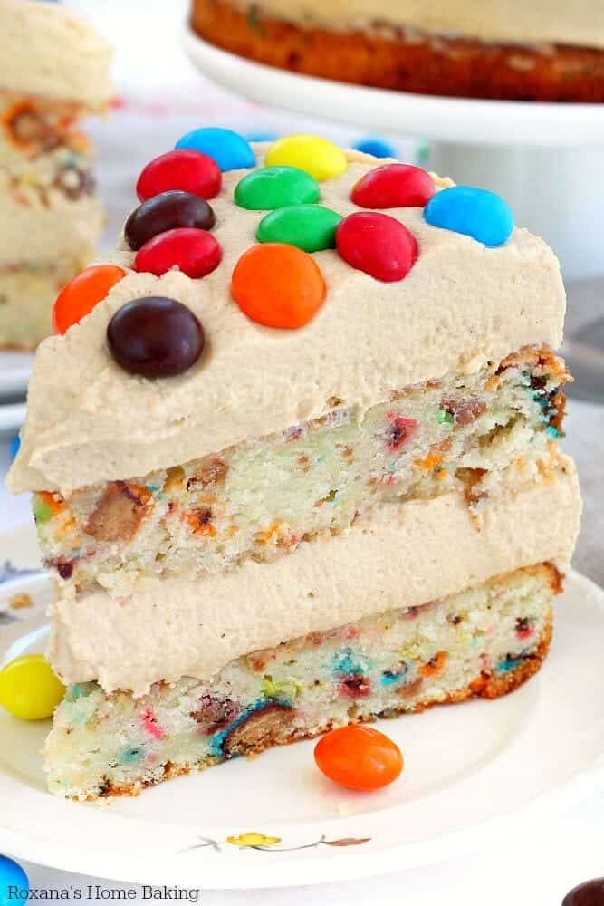 A close up of a piece of M&M peanut butter cake on a plate
