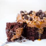 piece of chocolate turtle poke cake on a plate