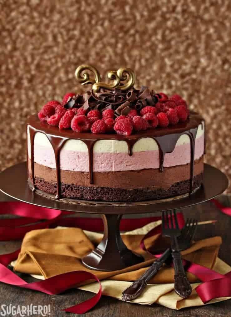 chocolate raspberry mousse cake on a brown cake stand 