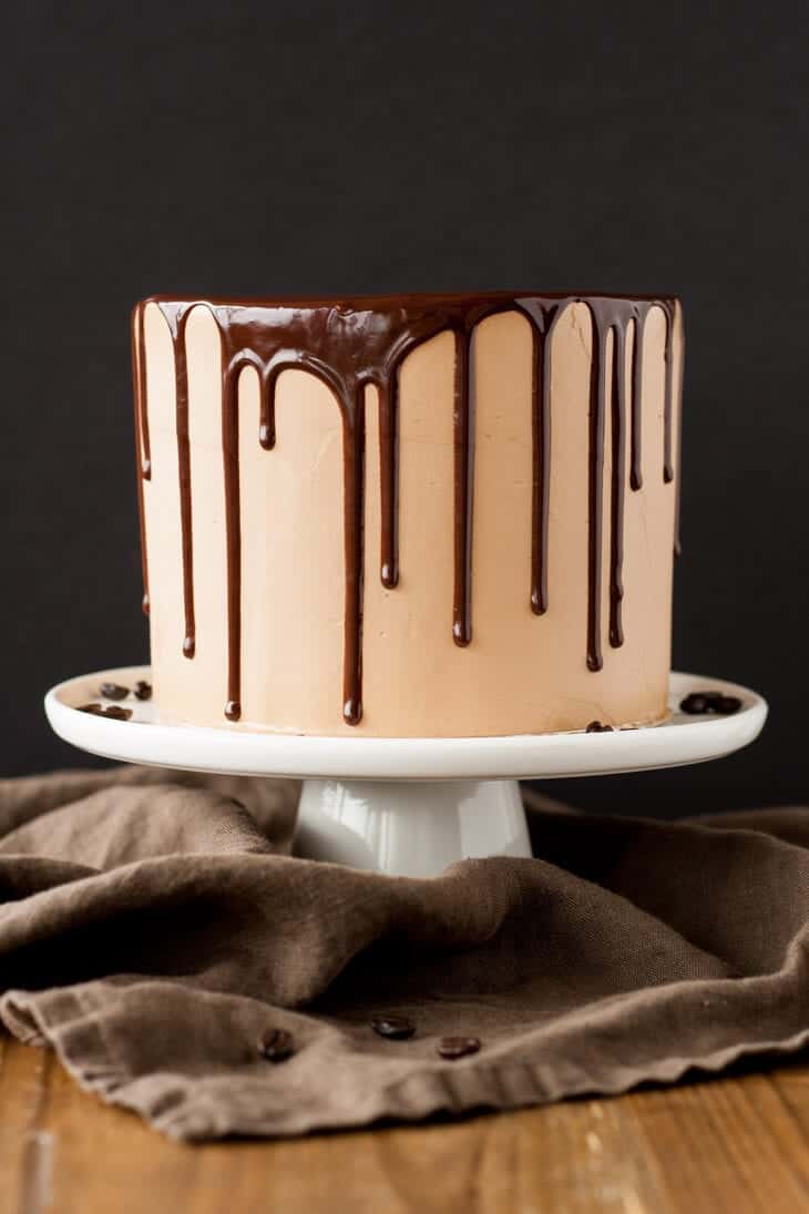 mocha cake with chocolate ganache dripping down the sides 