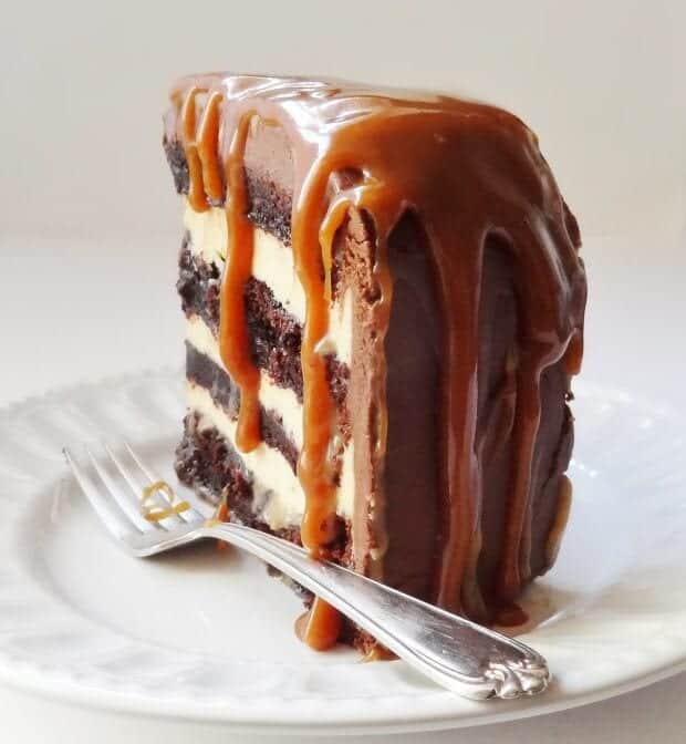 piece of salted caramel chocolate fudge cake on a plate with a fork 