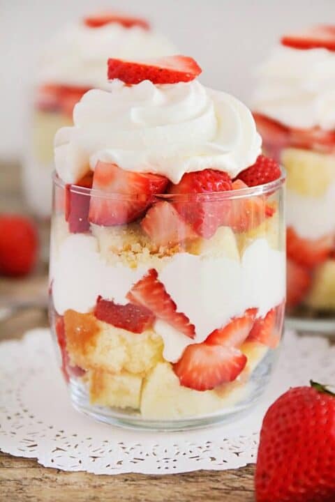 strawberry trifle topped with whipped cream and a fresh strawberry 