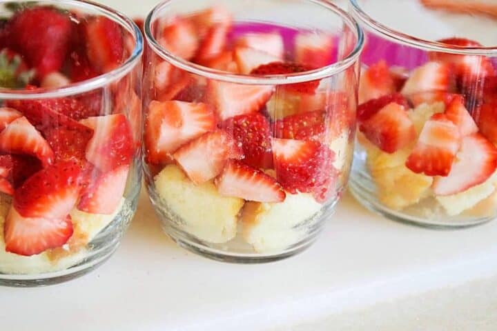 assembling mini strawberry shortcake trifles 