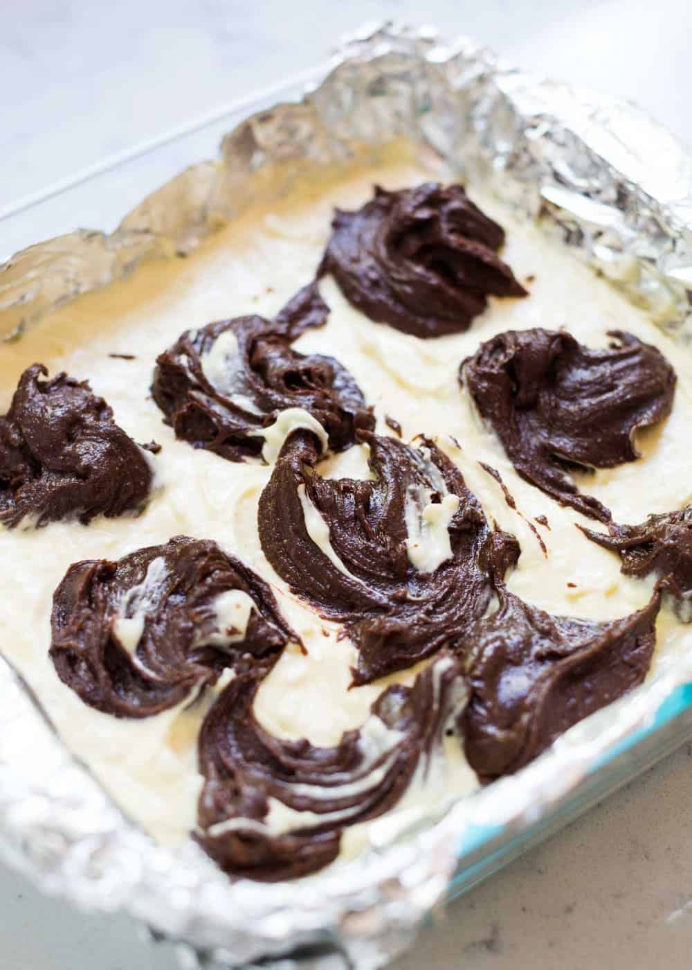Swirling the cheesecake brownie layers together.