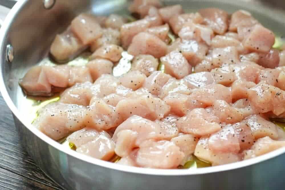 Cooking diced chicken on the stove.