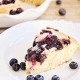 piece of blueberry buttermilk cake on a white plate