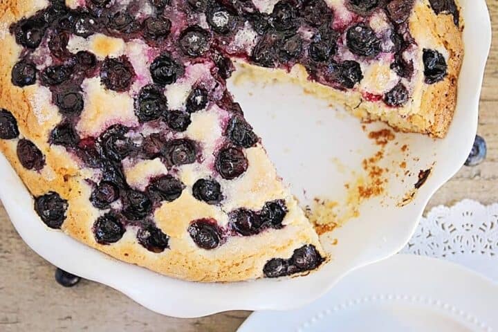 blueberry buttermilk cake with a slice taken out 