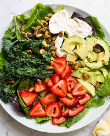 strawberry burrata salad on a white plate