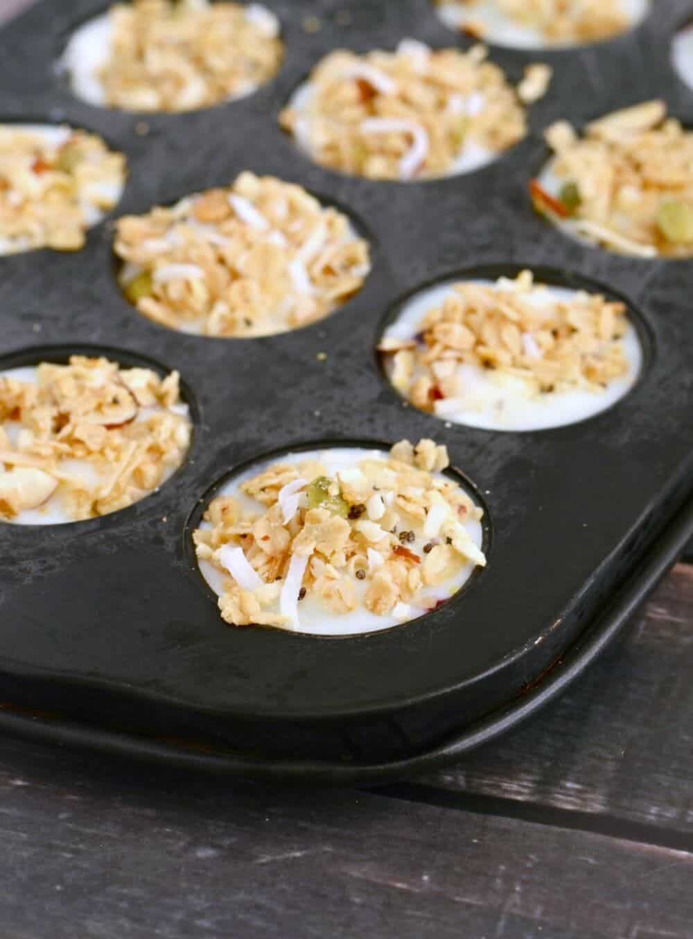 Mini muffin tin full of yogurt granola bites.