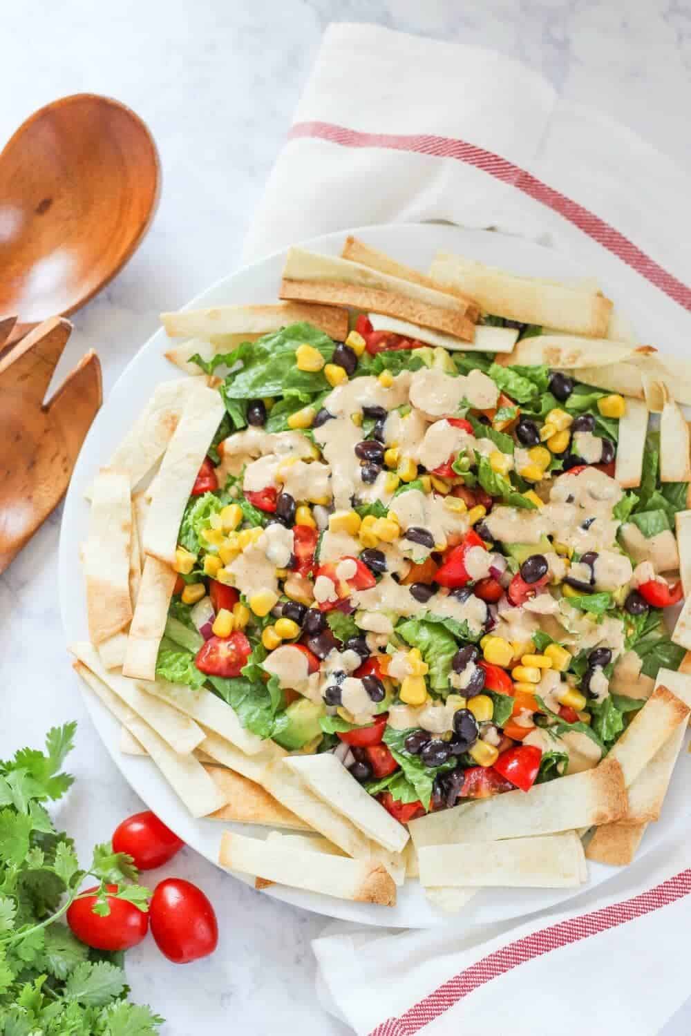 Mexican salad on a plate with tortilla strips.