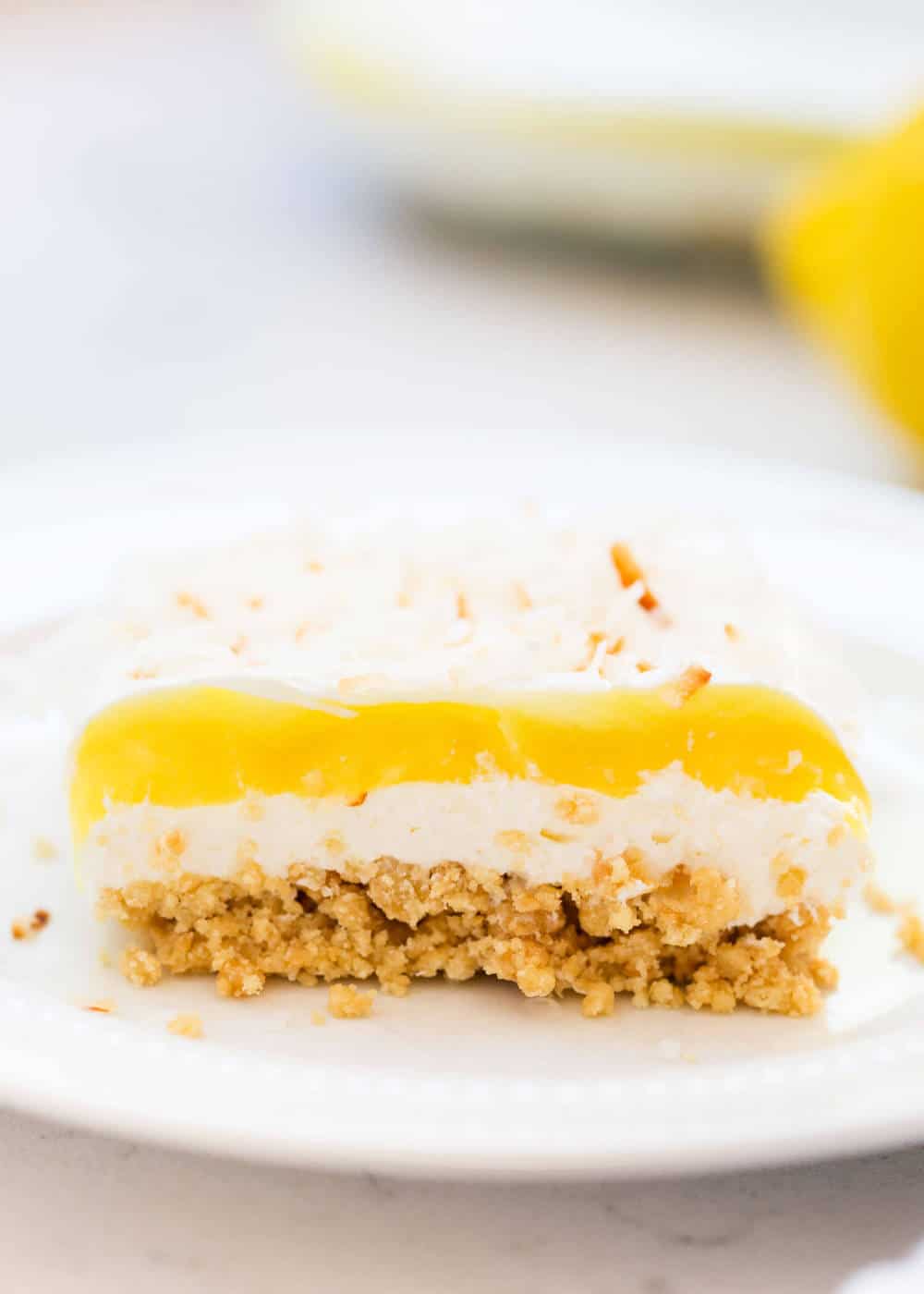 Piece of lemon lasagna on a white plate.