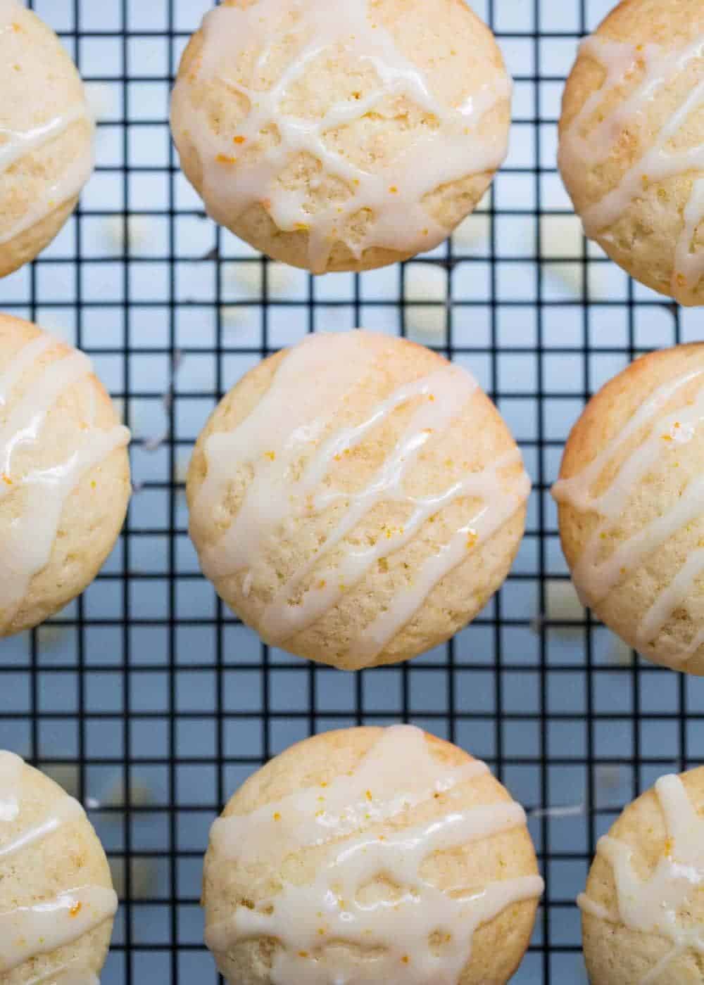 Glazed orange muffins on a baking rack.