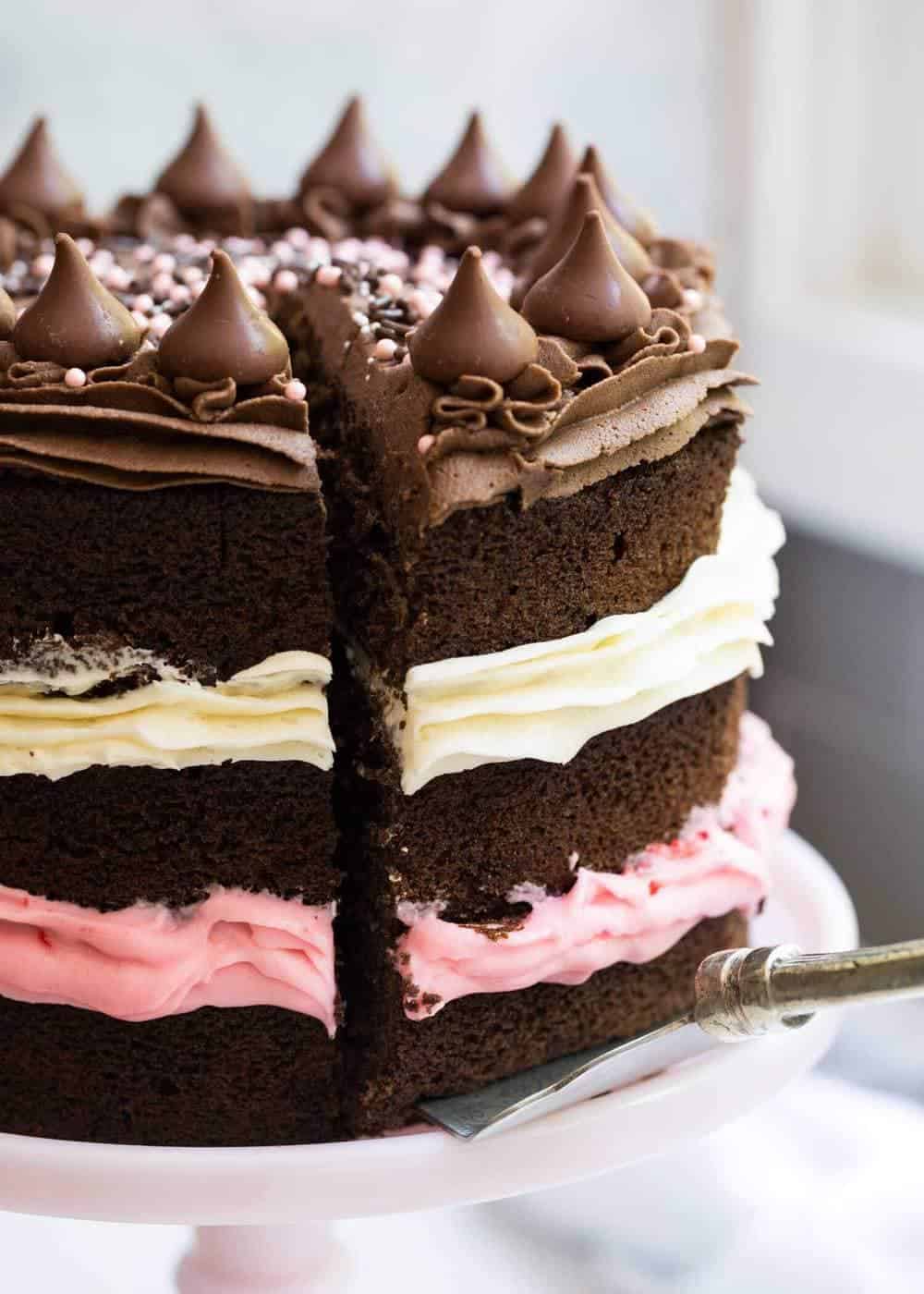 cutting out a slice of Neapolitan cake 