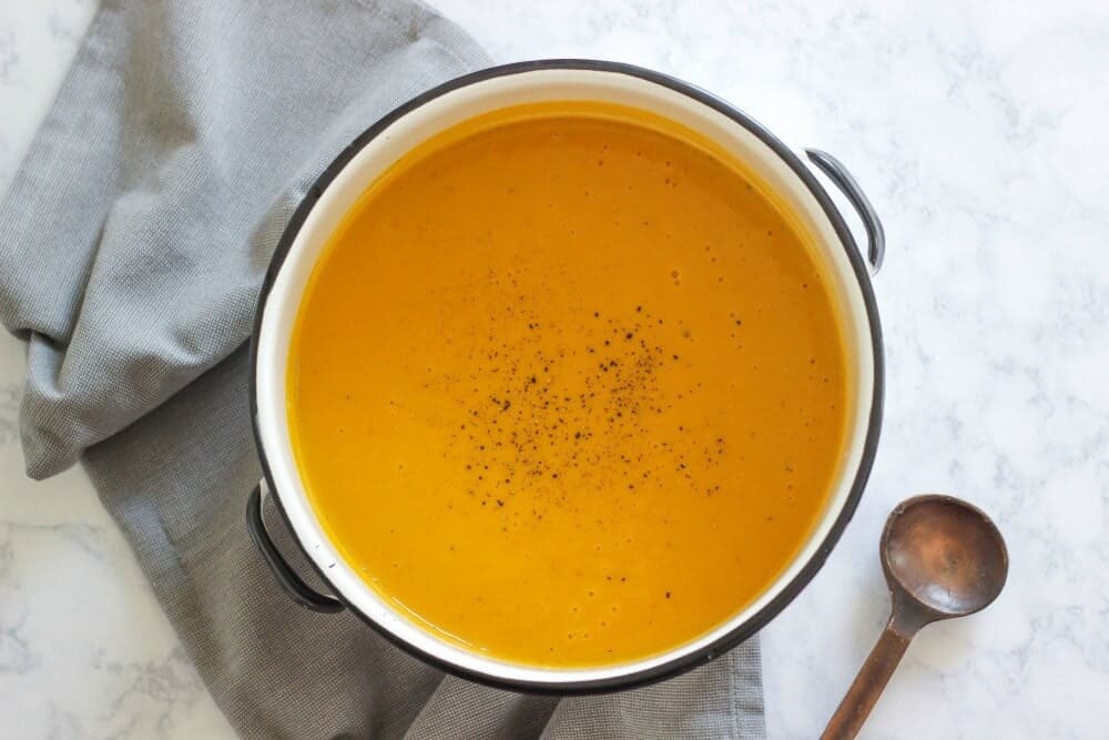 bowl of creamy sweet potato soup with pepper on top 