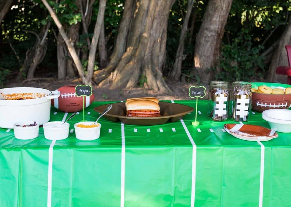 Tailgating chili bar with chili, hot dogs and corn dog muffins.