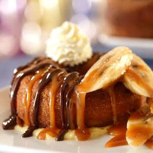 cronut smothered with bananas, chocolate and caramel sauce