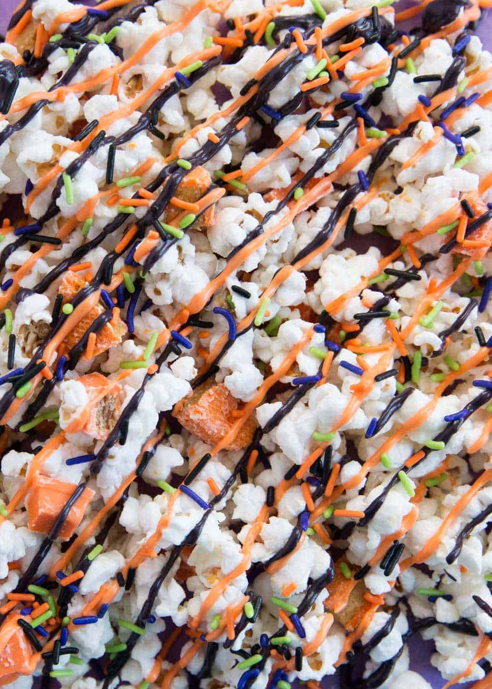 halloween candy popcorn covered in white chocolate mixed with kit kat bars and reeses so