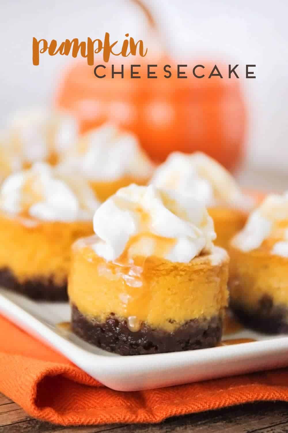 Mini pumpkin cheesecakes on plate.