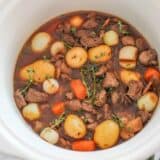 Slow Cooker Beef Bourguignon ...an easy and hearty holiday meal made with beef, burgundy wine, fresh vegetables and herbs. The alcohol is cooked out, leaving a rich and thick liquid for the beef and vegetables to cook in.