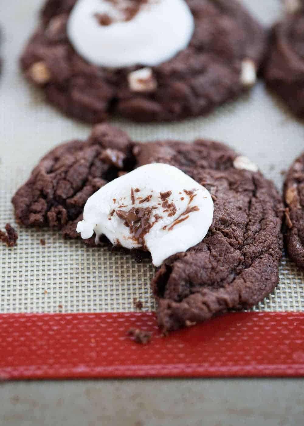 Bite taken out of a hot cocoa cookie.