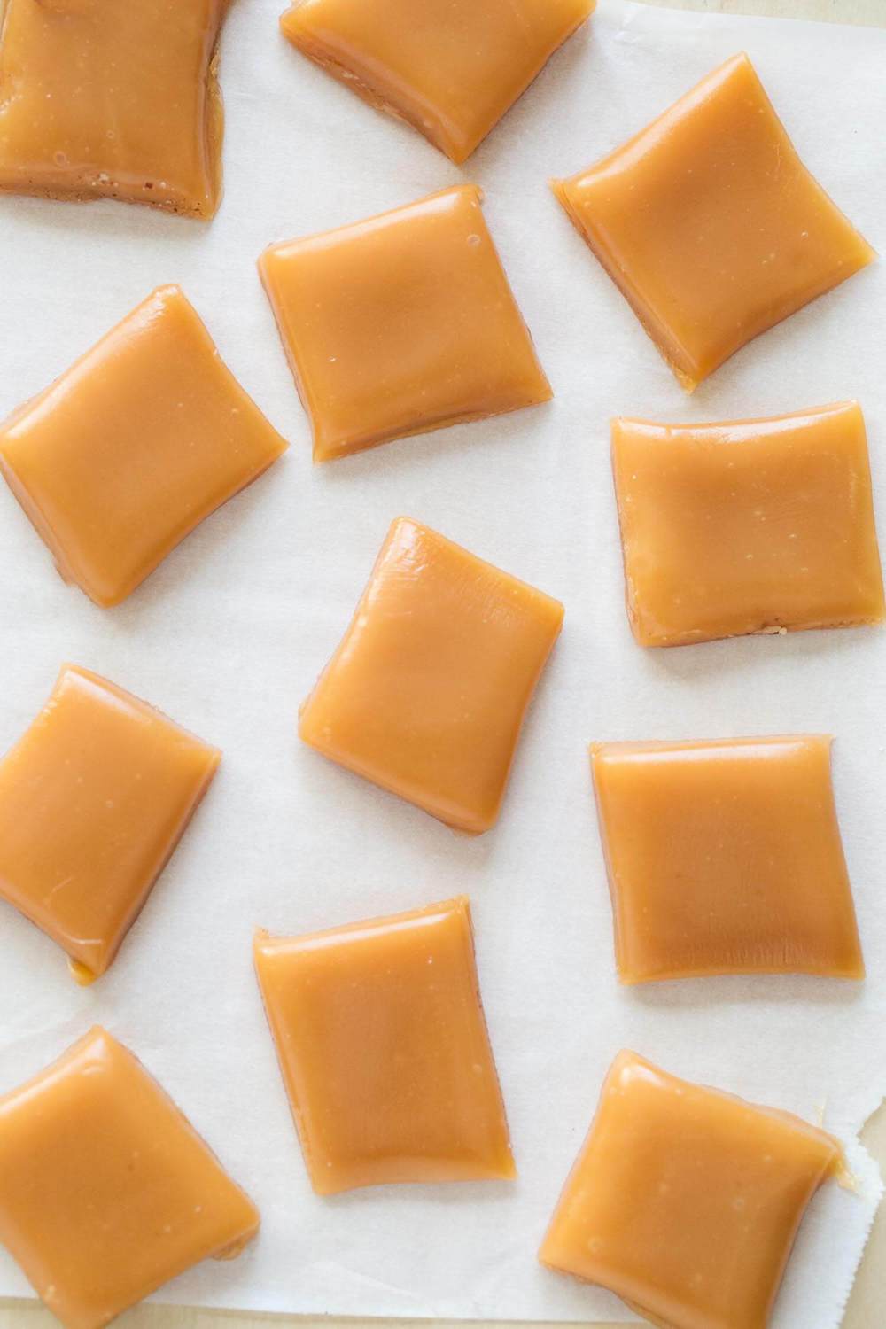 Cut caramel candy on wax paper.