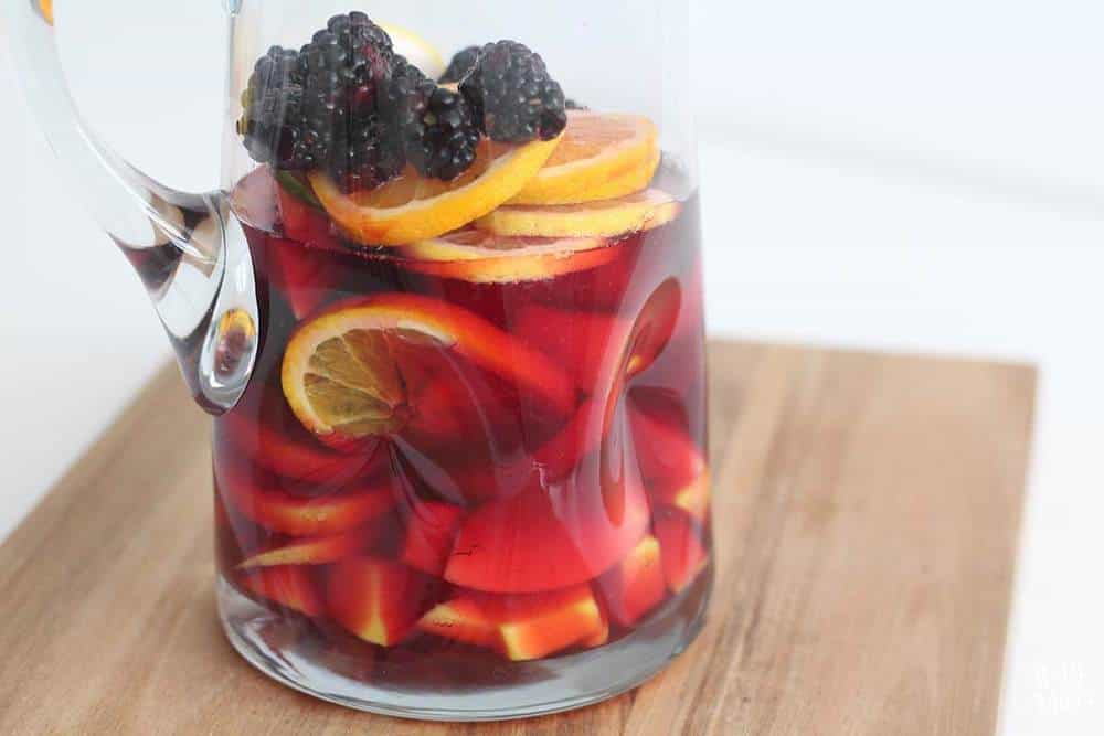 Non-alcoholic sangria in a glass pitcher.