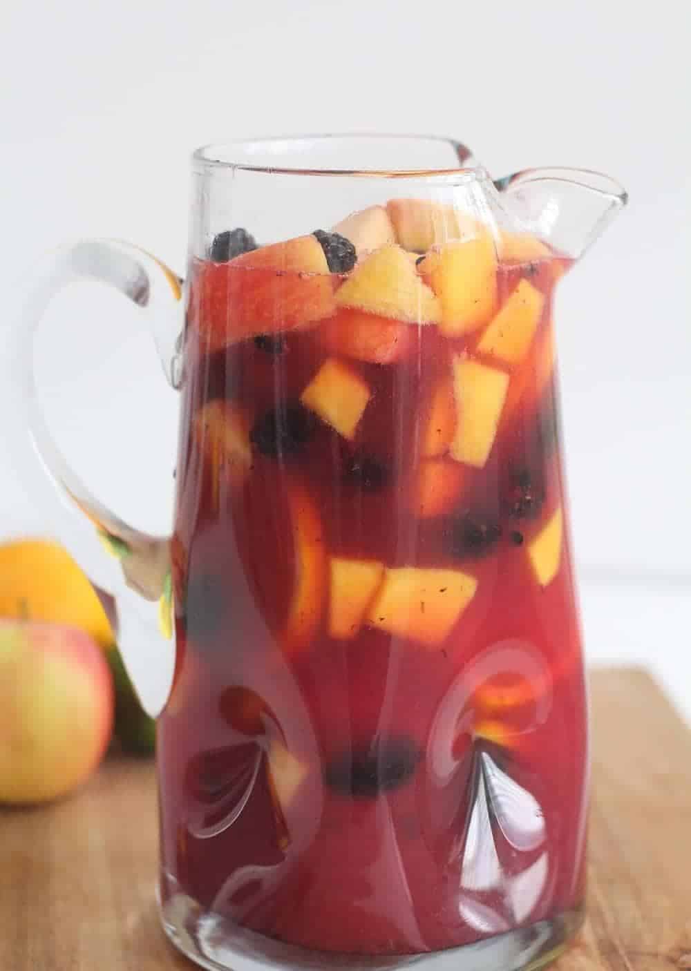Non-alcoholic sangria in a glass pitcher.