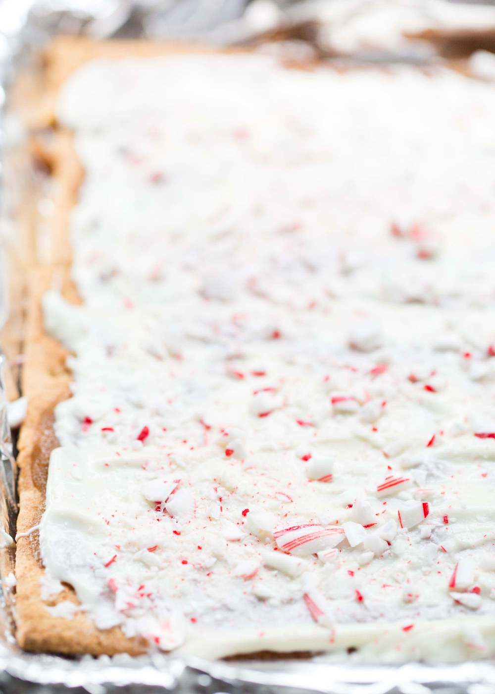 Graham cracker toffee with white chocolate and crushed peppermint on top.