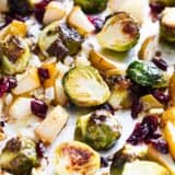 roasted brussels sprouts with cranberries and pears on baking sheet