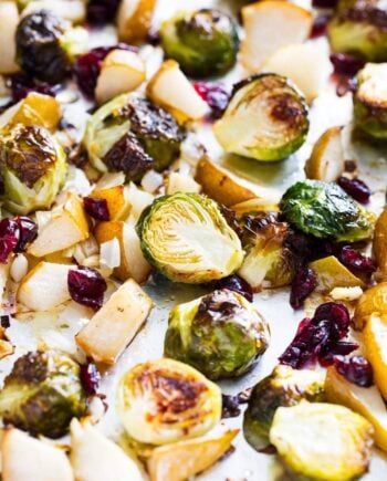 roasted brussels sprouts with cranberries and pears on baking sheet