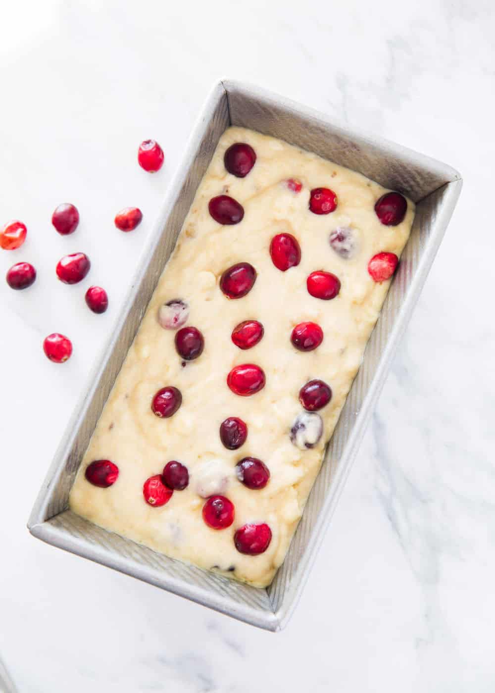Cranberry banana bread in loaf pan ready to bake.