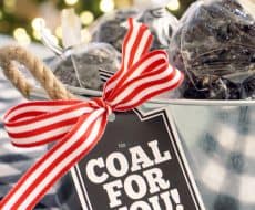 Coal Popcorn Balls... putting a twist on the ever-favorite popcorn balls by creating a licorice caramel to make these amazing Coal Popcorn Balls. Free printable, perfect for gifting, included!