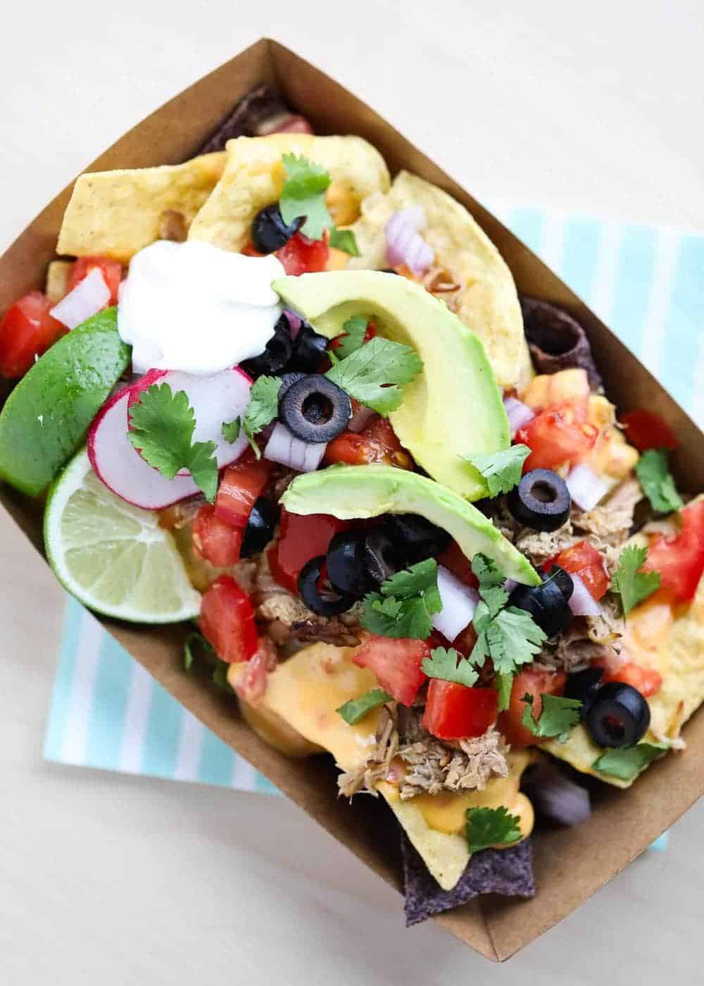 Nachos in a paper nacho tray.