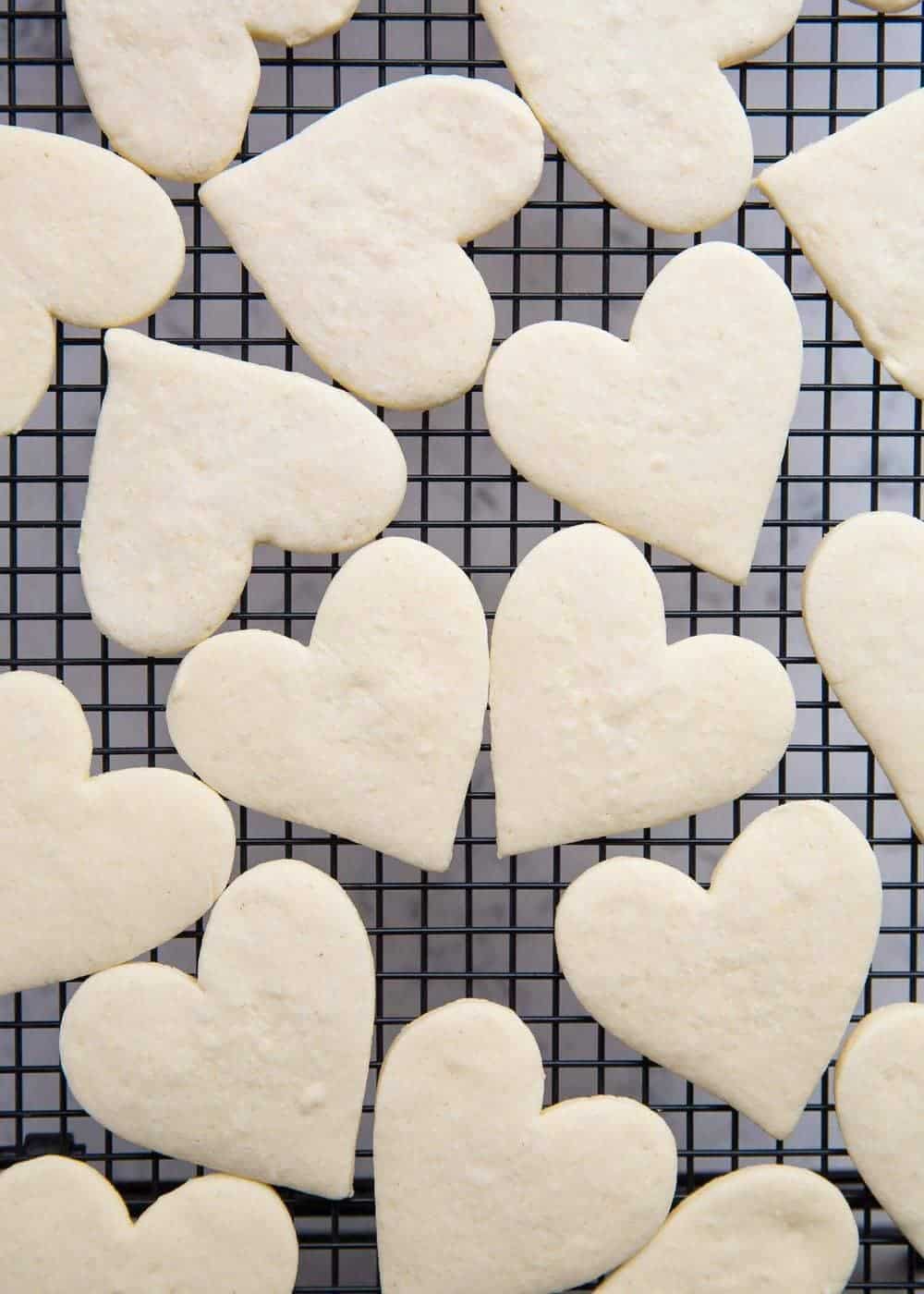 Heart shaped empire biscuits on cooling rack.
