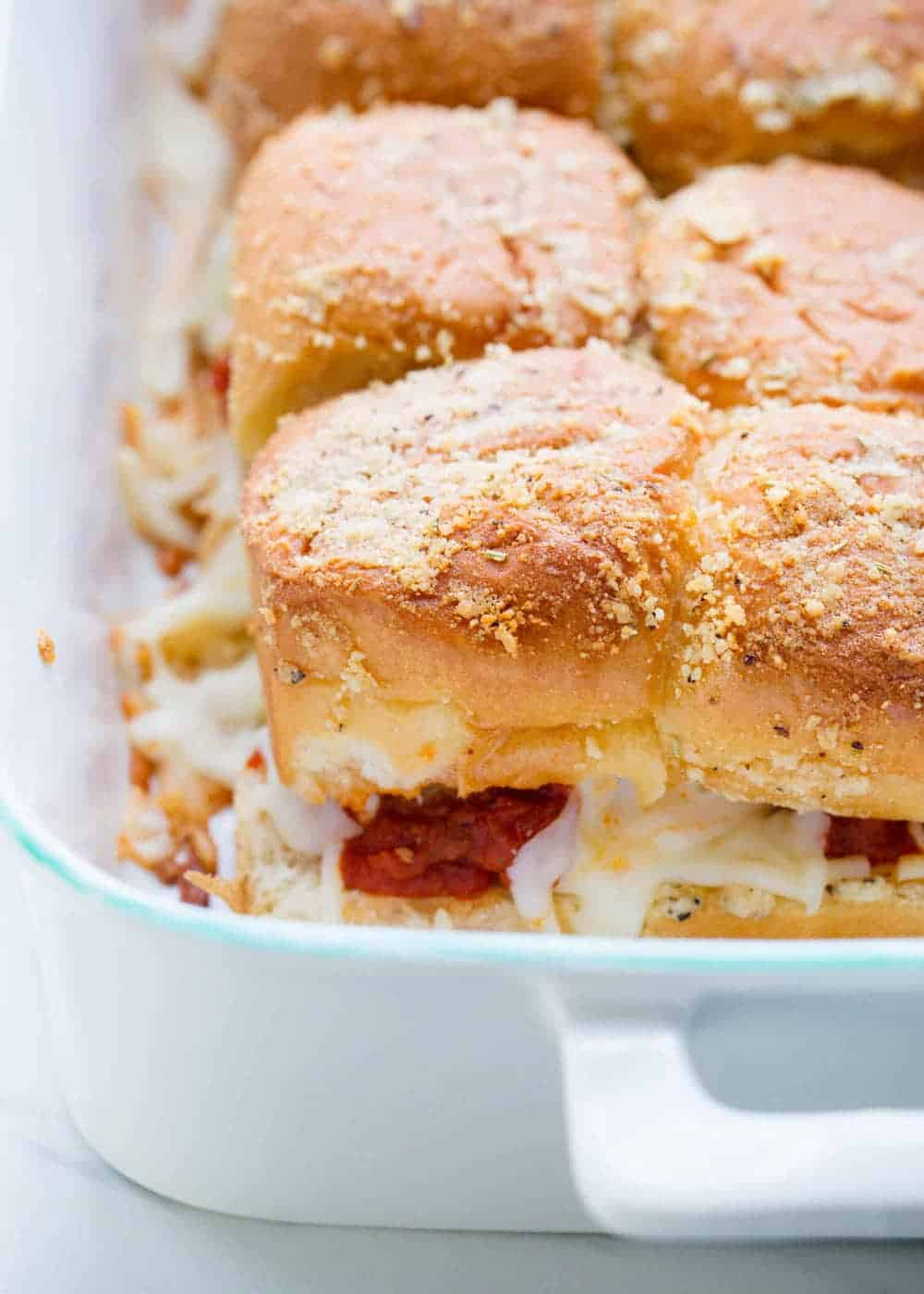 Meatball sliders baked in a casserole dish. 