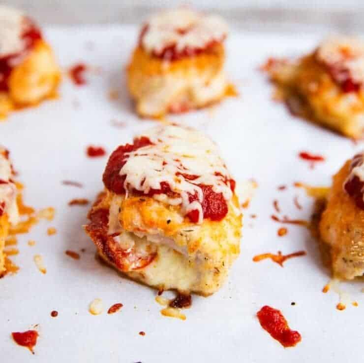 Pizza stuffed chicken on a sheet pan. 