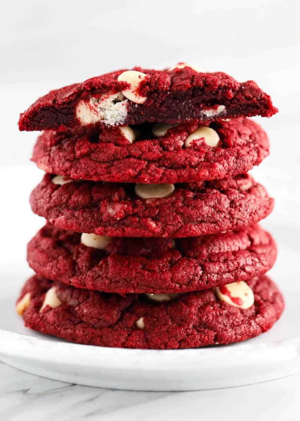 Stack of red velvet cake mix cookies on plate.