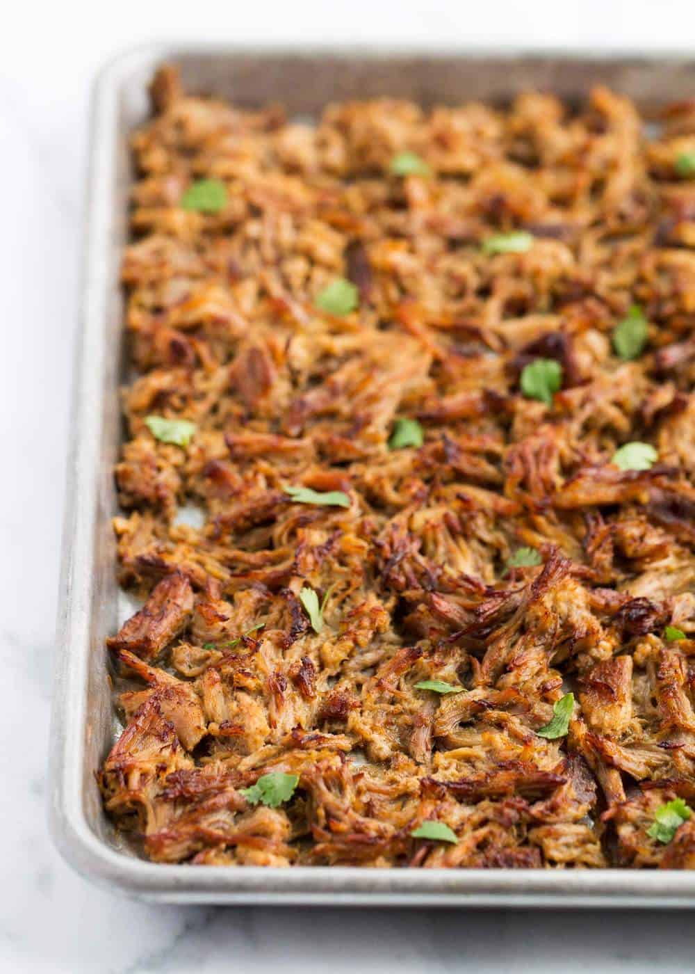 Crispy carnitas on a baking sheet.