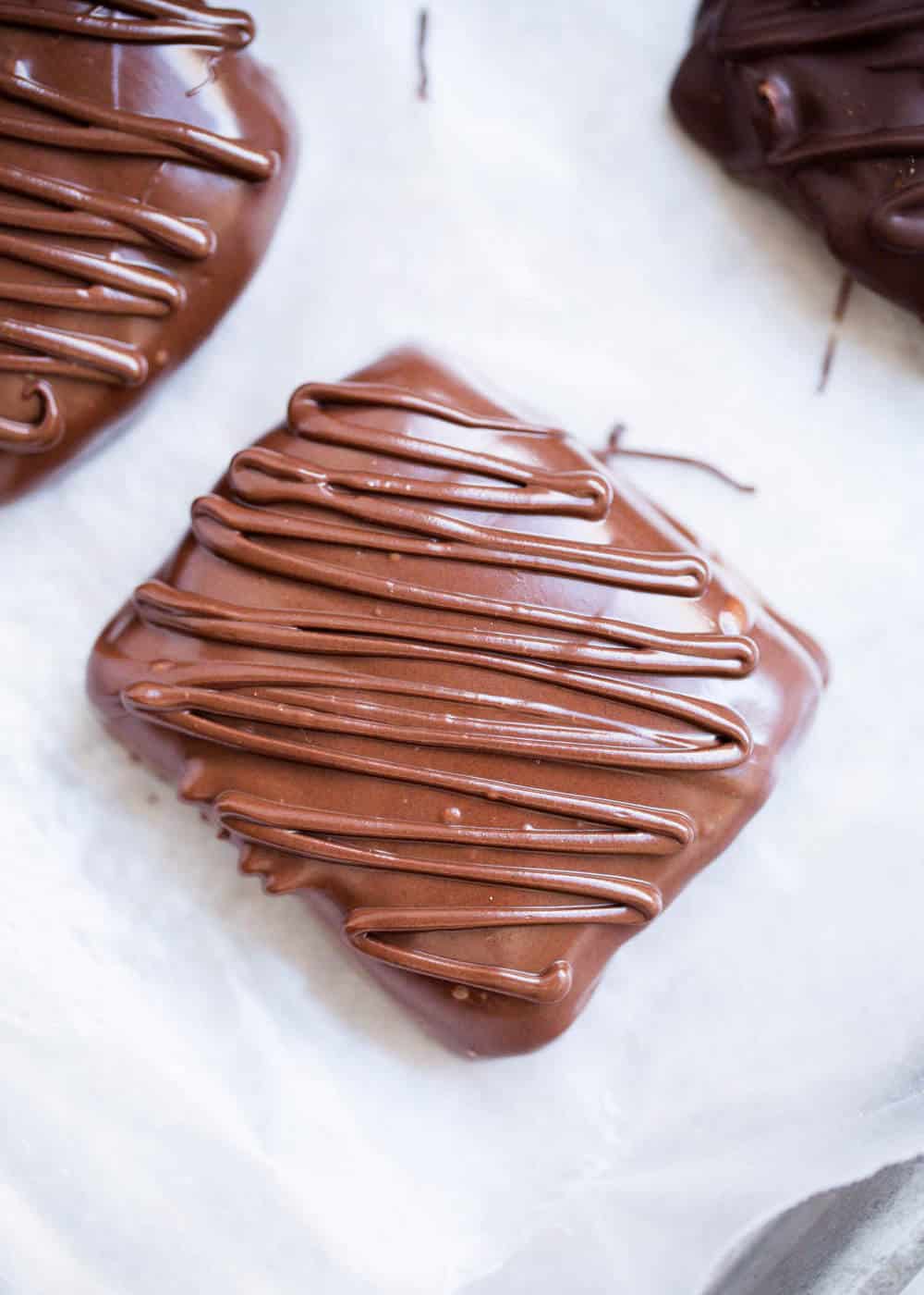 Peanut butter graham cracker sandwich drizzled with chocolate.