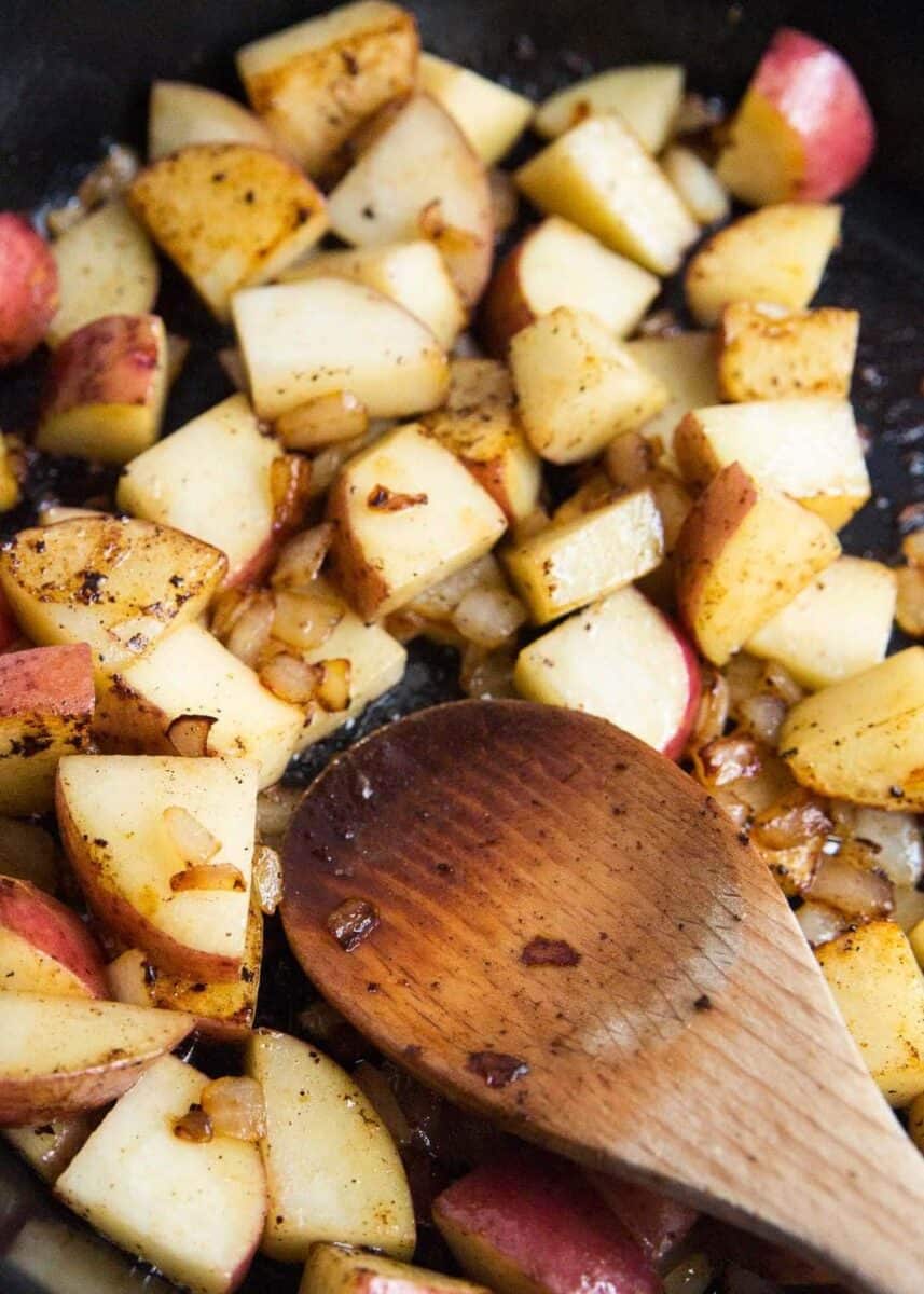 cooking diced potatoes in pan 