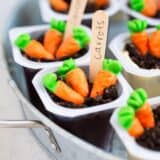 A close up of spring pudding cups with candy carrots