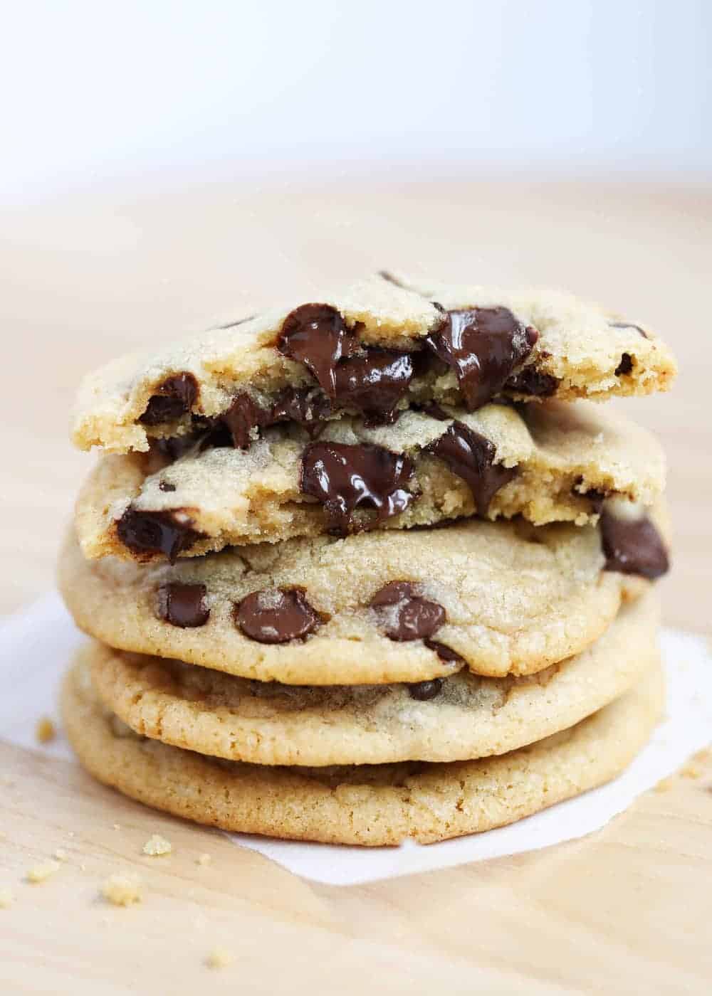 Stack of brown butter chocolate chip cookies on a wood table.