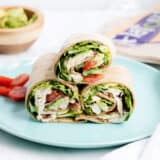 Chicken Caesar Wraps ...a quick, delicious lunch or appetizer that is light on calories! These Chicken Caesar Wraps feature crispy bacon, juicy tomatoes, avocado, lettuce and Caesar dressing.