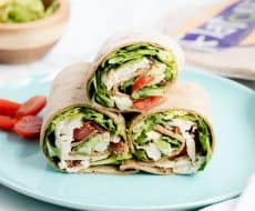 Chicken Caesar Wraps ...a quick, delicious lunch or appetizer that is light on calories! These Chicken Caesar Wraps feature crispy bacon, juicy tomatoes, avocado, lettuce and Caesar dressing.