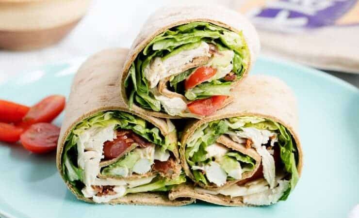 Chicken Caesar Wraps ...a quick, delicious lunch or appetizer that is light on calories! These Chicken Caesar Wraps feature crispy bacon, juicy tomatoes, avocado, lettuce and Caesar dressing.