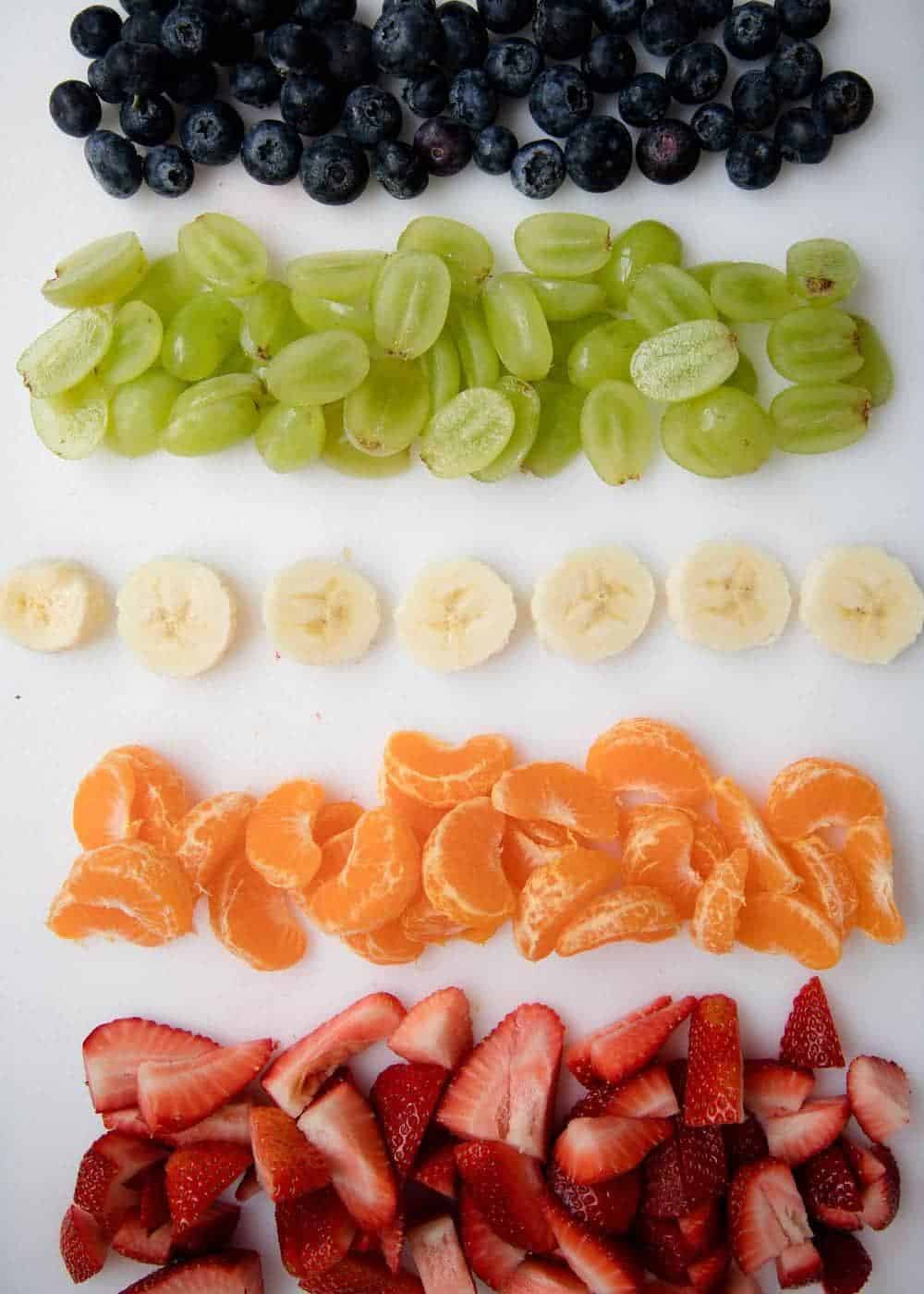 Chopped fruit on cutting board.