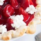 close up of fresh strawberry pie with whipped cream